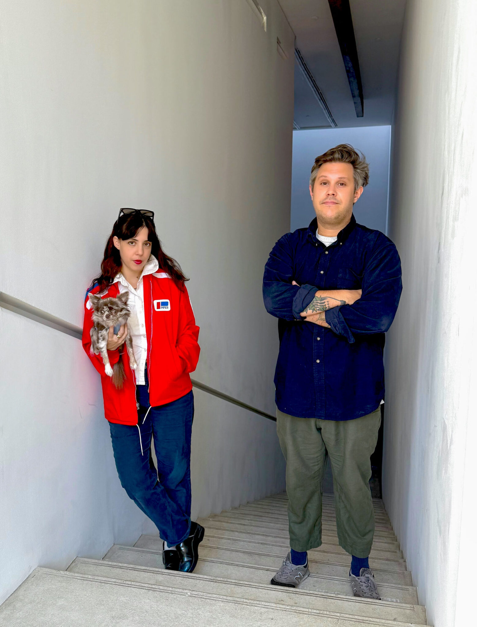 woman and man stand in a stairwell