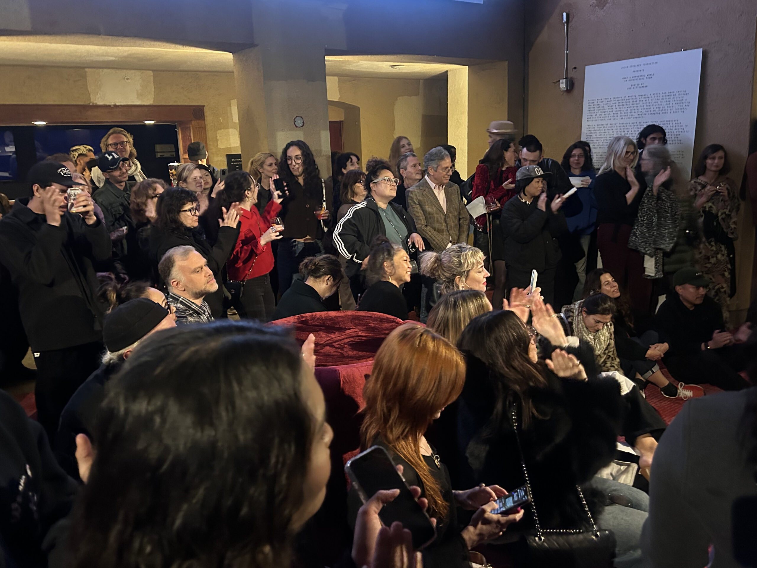 Visitors watching the band War Pigs in the lobby on Feb. 15 with Fiona Duncan, “founding host” of "Hard to Read" in the foreground (bright red/orange hair), on her phone.