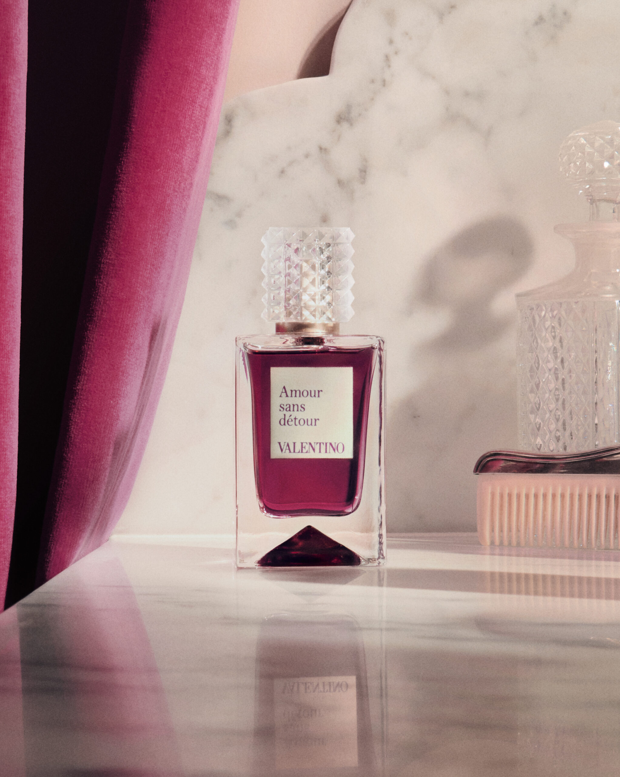 A perfume bottle is positioned for Valentino's Analog of Dreams campaign
