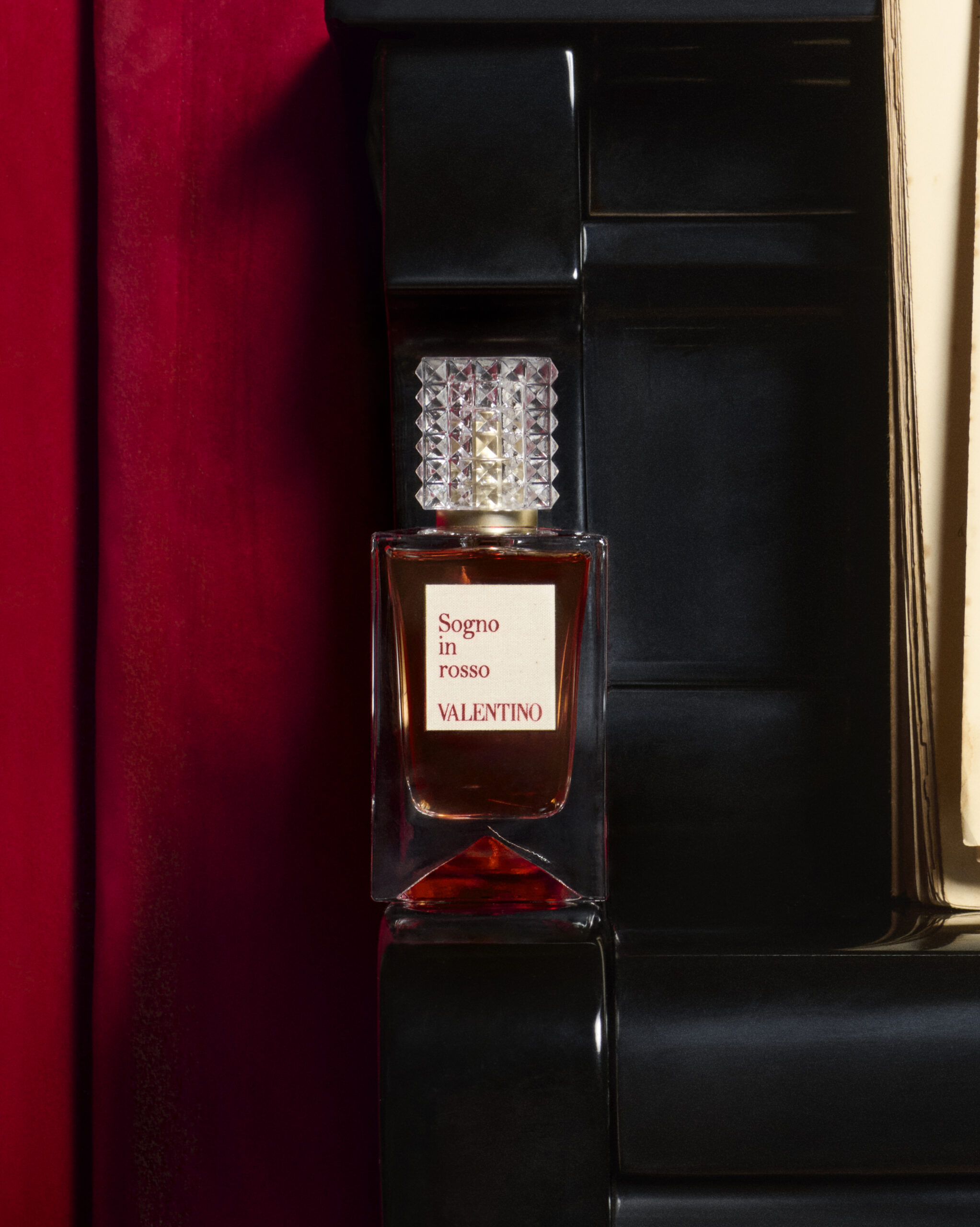 A perfume bottle is positioned for Valentino's Analog of Dreams campaign