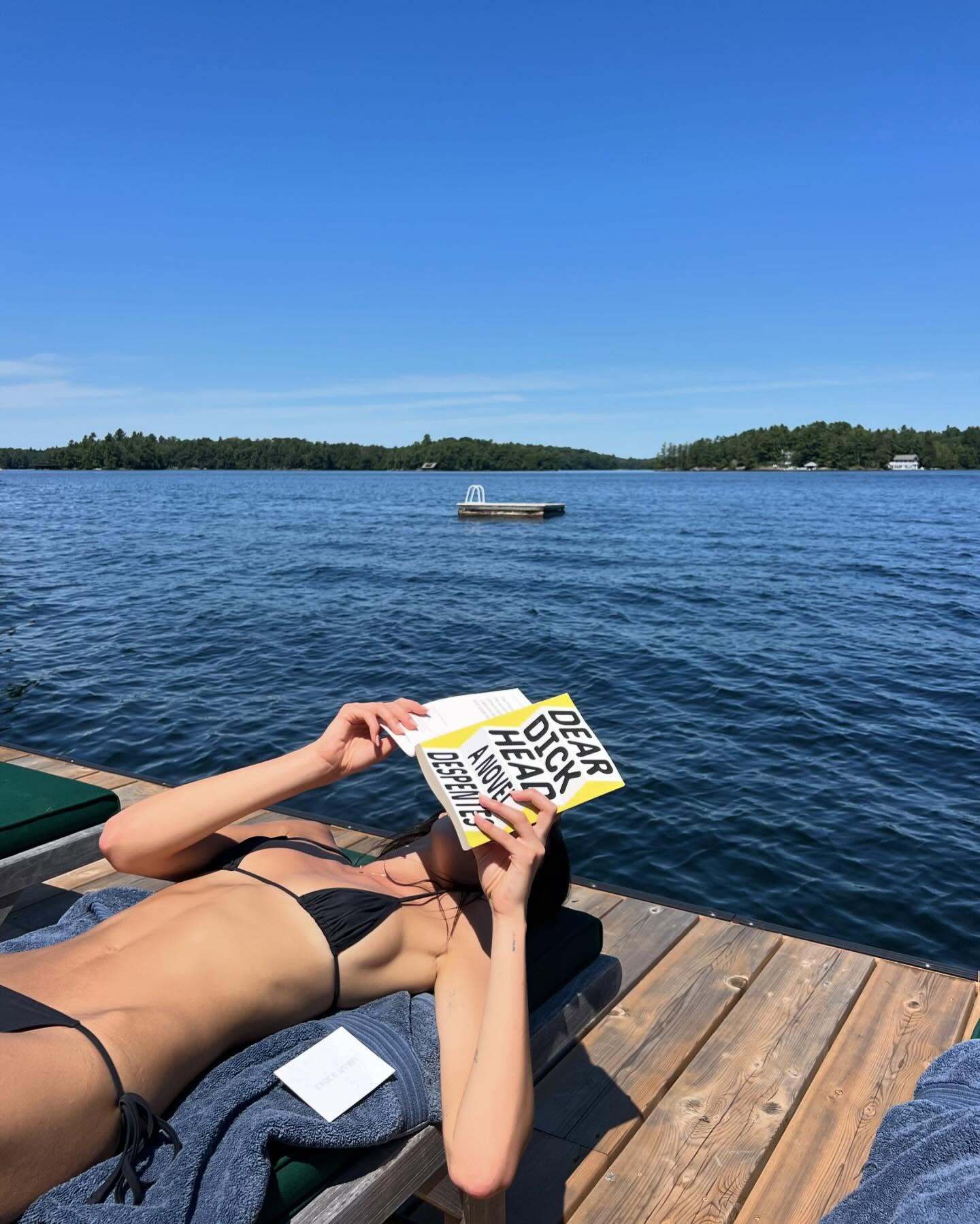 Model and actress Kaia Gerber, daughter of supermodel Cindy Crawford, reads Dear Dickhead: A Novel by French author Virginie Despentes on a pier.