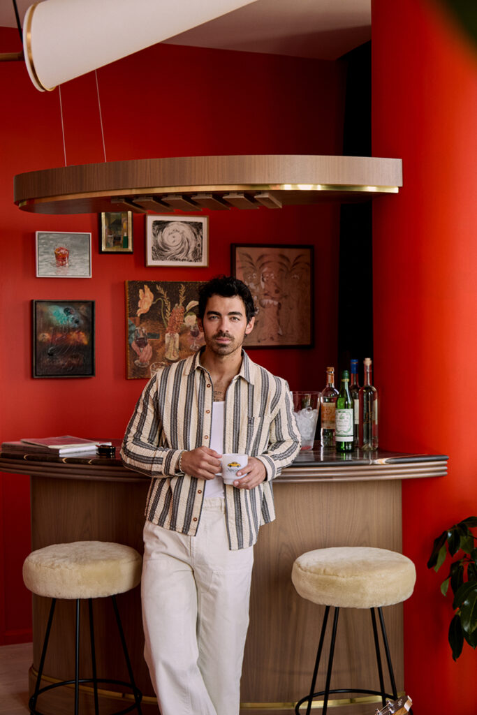 Singer, songwriter, actor, and art collector Joe Jonas of the Jonas Brothers in his Dumbo Olympia Apartment in Brooklyn. He is in his lounge, speakeasy, and vinyl listening room