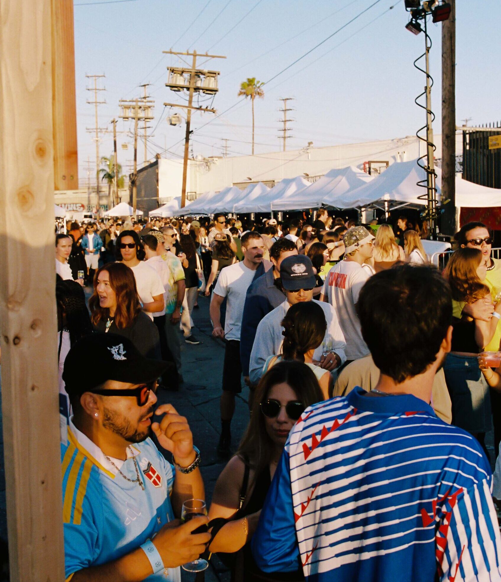 The Good Boy & Friends Festival with tents and crowds against a blue sky
