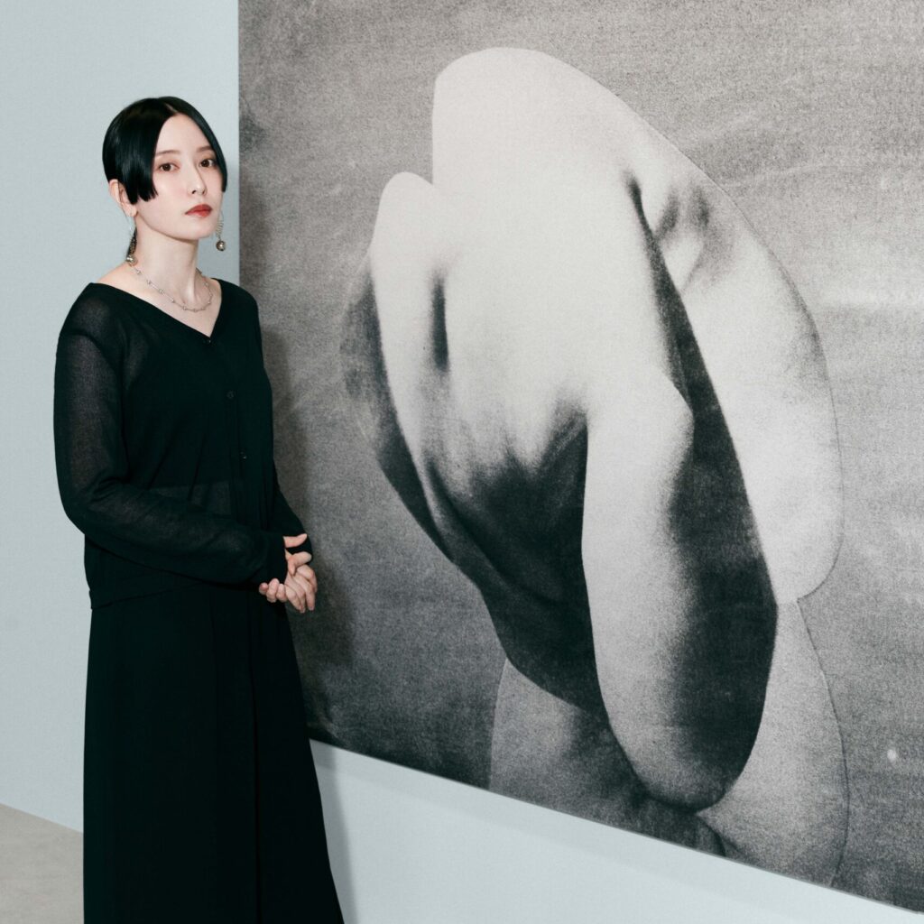 Dior Beauty Photography and Visual Arts Award for Young Talent winner Akari Takenobu standing next to her art
