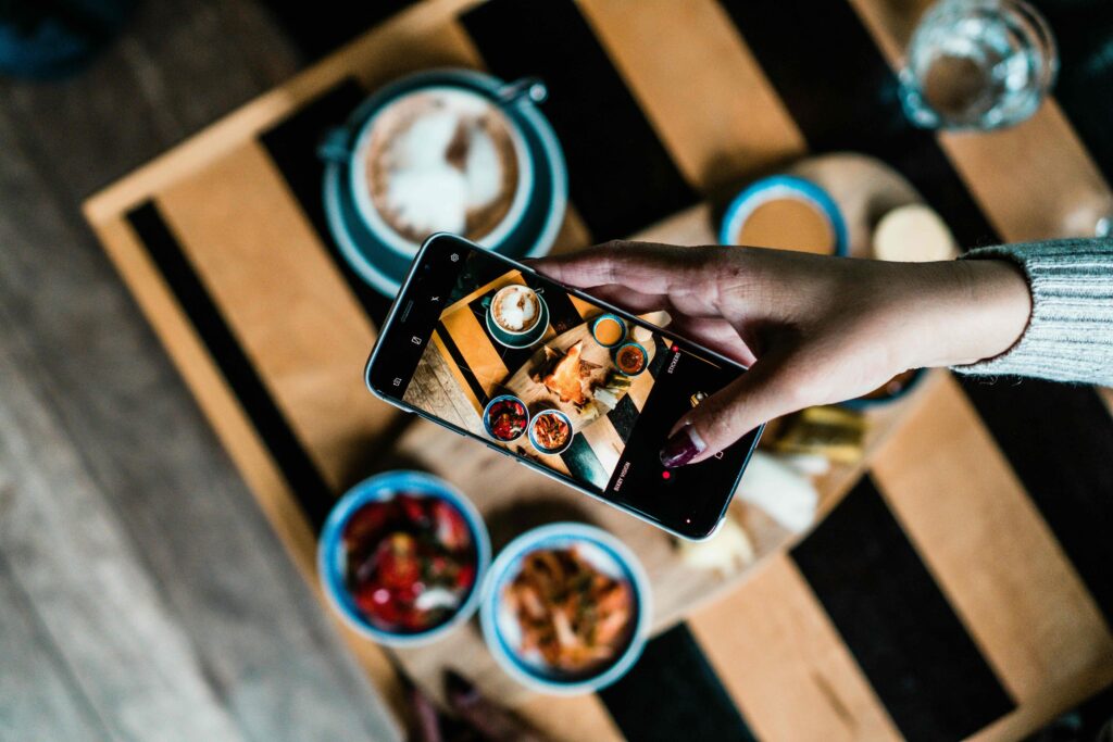 Picture of someone taking a photo of food
