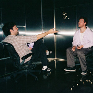 Alex Gruszynski and Aidan Cullen play games while being choreographed in a steel-lined room