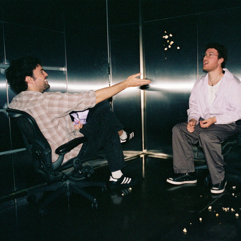 Alex Gruszynski and Aidan Cullen play games while being choreographed in a steel-lined room